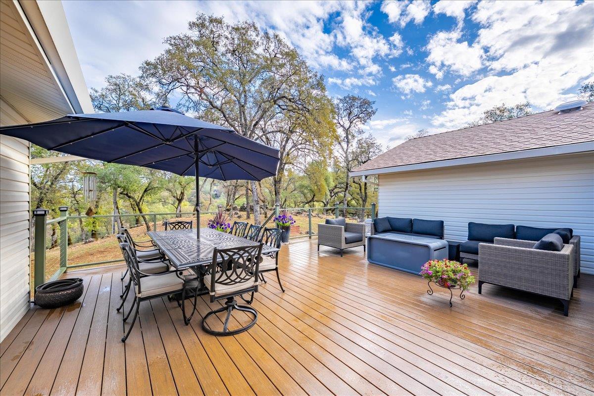 2540 Muir Court Cool, CA 95614 - Photo 46 of 97 a view of a roof deck with table and chairs under an umbrella with wooden floor