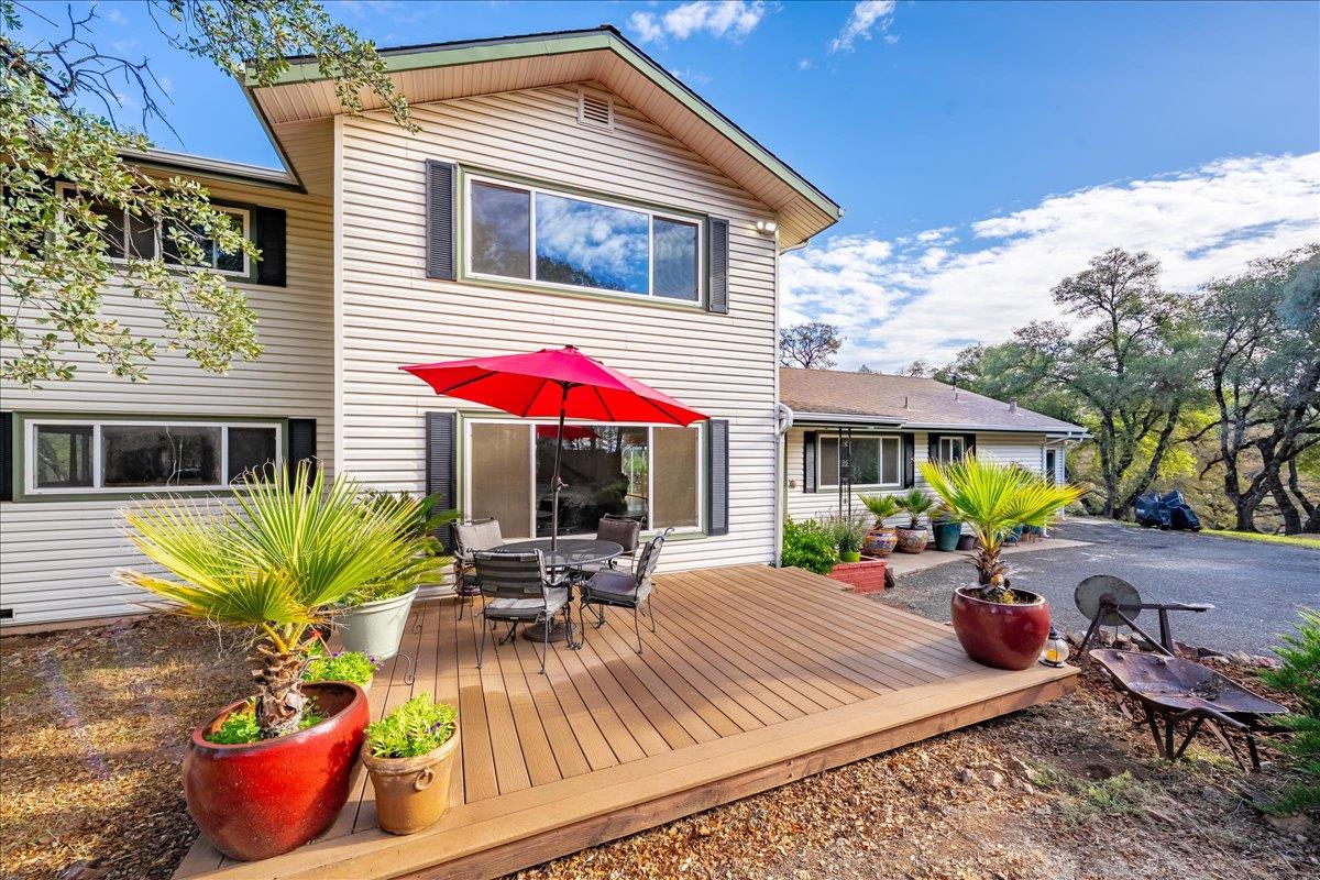 2540 Muir Court Cool, CA 95614 - Photo 8 of 97 front of property with a wooden deck, a patio area, and outdoor dining space