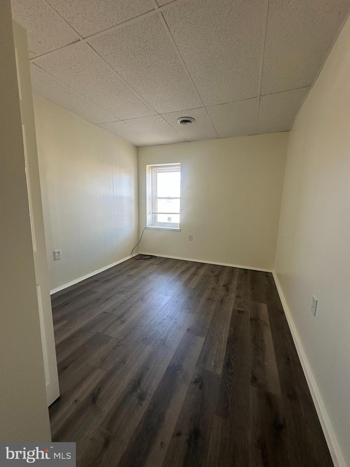 2300 South 12th Street, Unit 3F Philadelphia, PA 19148 - Photo 12 of 15 an empty room with wooden floor and windows