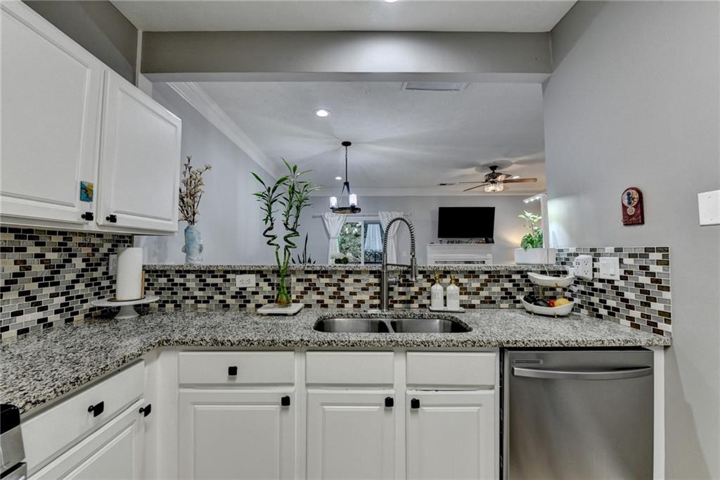 2066 Pinnacle Pointe Drive Norcross, GA 30071 - Photo 12 of 56 a bathroom with a granite countertop sink and a white cabinets