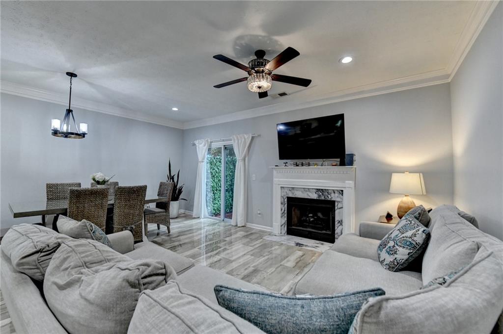 2066 Pinnacle Pointe Drive Norcross, GA 30071 - Photo 14 of 56 a living room with furniture a fireplace and a flat screen tv