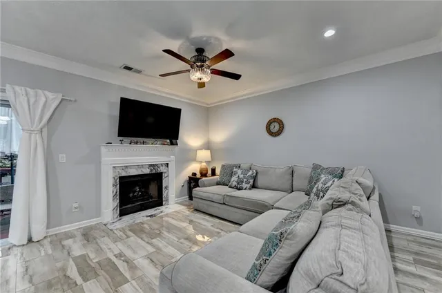 a living room with furniture and a ceiling fan