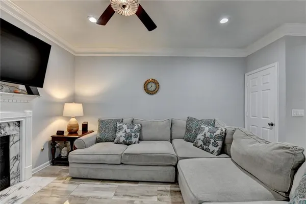 a living room with furniture and kitchen view
