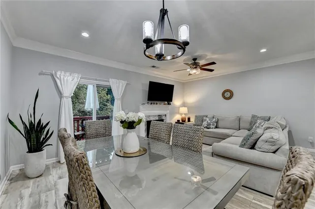 a kitchen with a table chairs and a living room view