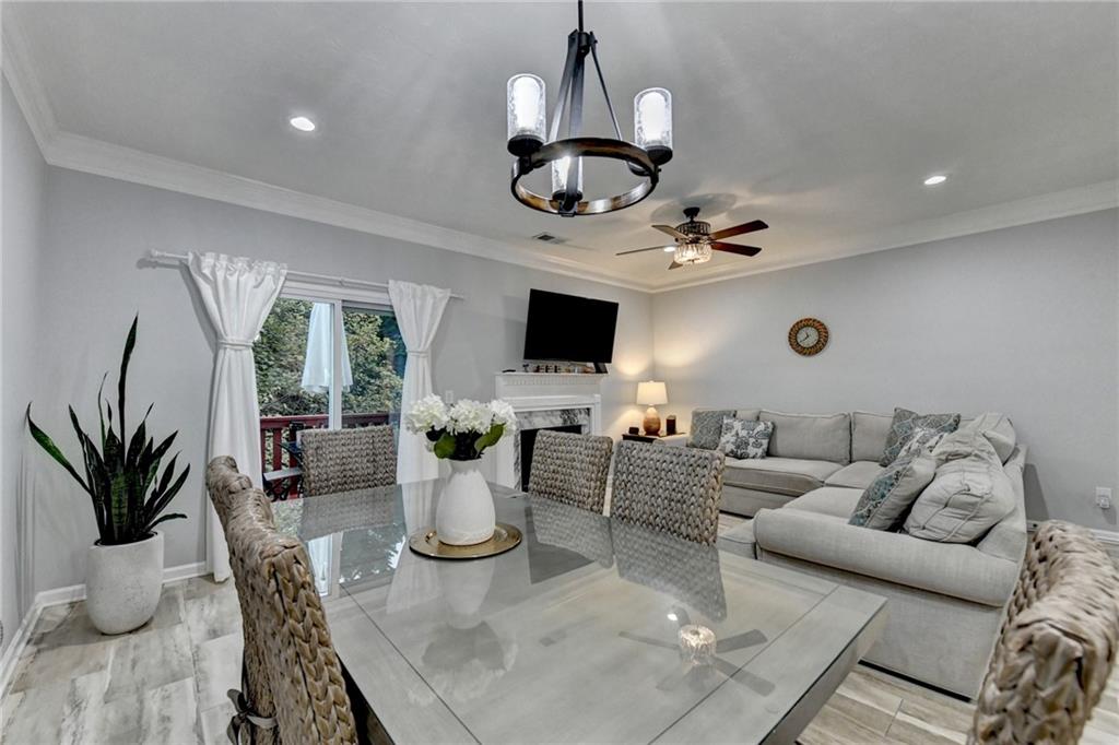 2066 Pinnacle Pointe Drive Norcross, GA 30071 - Photo 26 of 56 a living room with furniture a chandelier and a flat screen tv