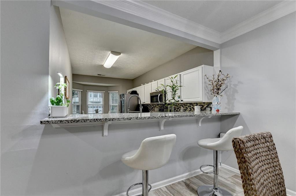 2066 Pinnacle Pointe Drive Norcross, GA 30071 - Photo 29 of 56 a kitchen with a table chairs and a living room view