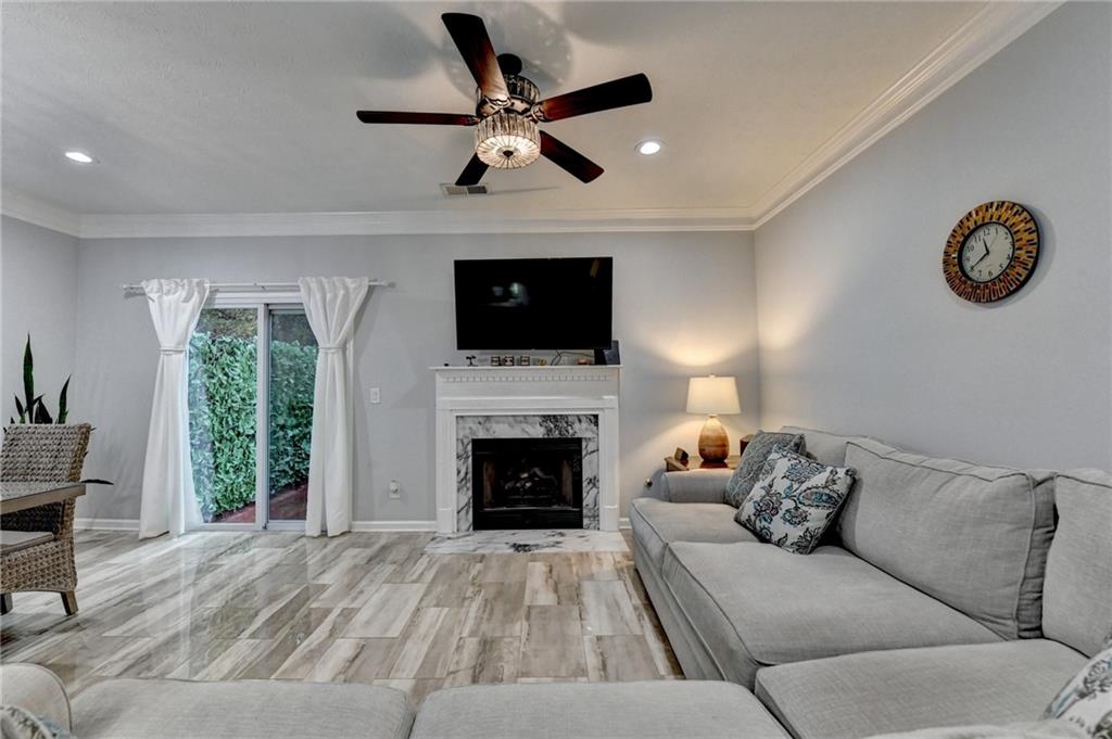 2066 Pinnacle Pointe Drive Norcross, GA 30071 - Photo 30 of 56 a living room with furniture a fireplace and a flat screen tv