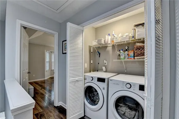 a bedroom with a bed and a flat tv screen on dresser