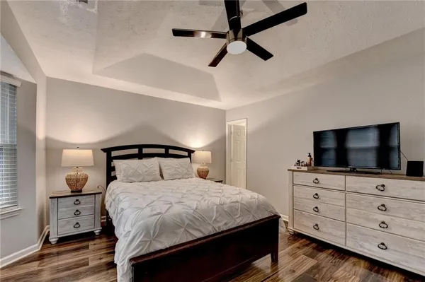 a bedroom with a large bed and a window