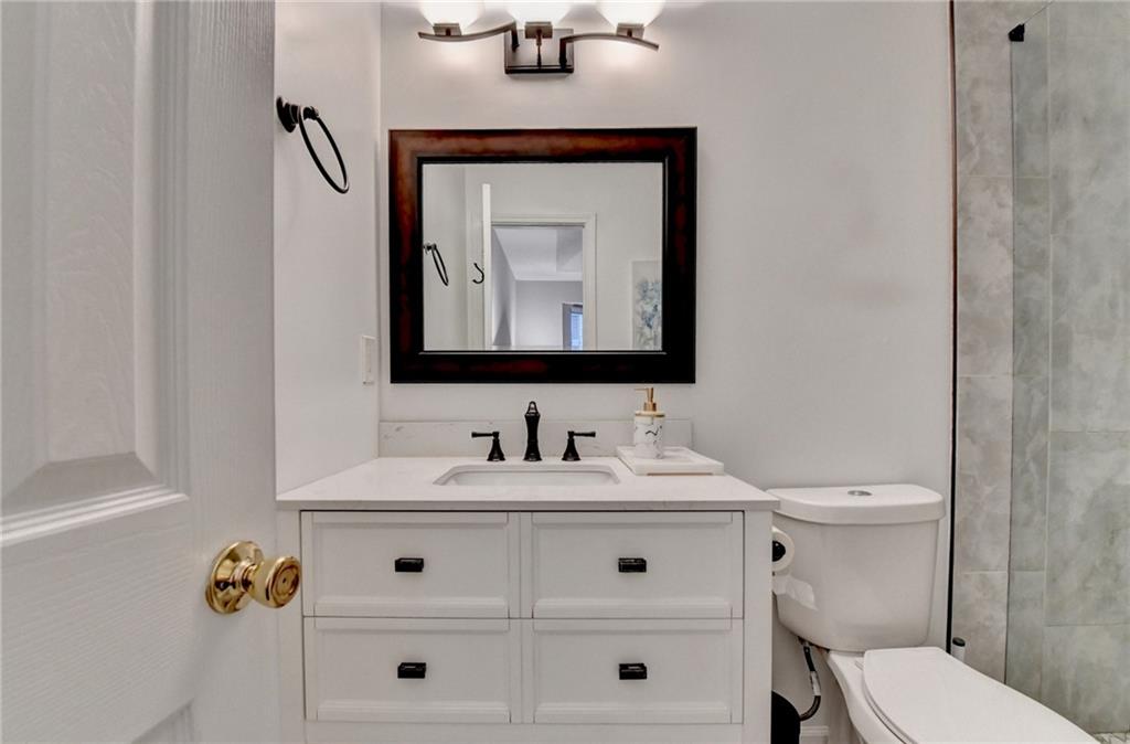 2066 Pinnacle Pointe Drive Norcross, GA 30071 - Photo 44 of 56 a bathroom with a toilet sink and mirror