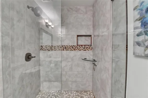 a room with wooden floor and ceiling fan