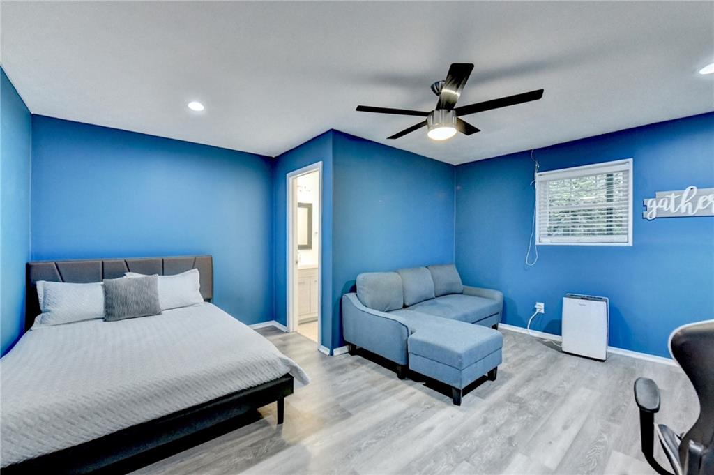 2066 Pinnacle Pointe Drive Norcross, GA 30071 - Photo 51 of 56 a bedroom with a bed couch and a ceiling fan