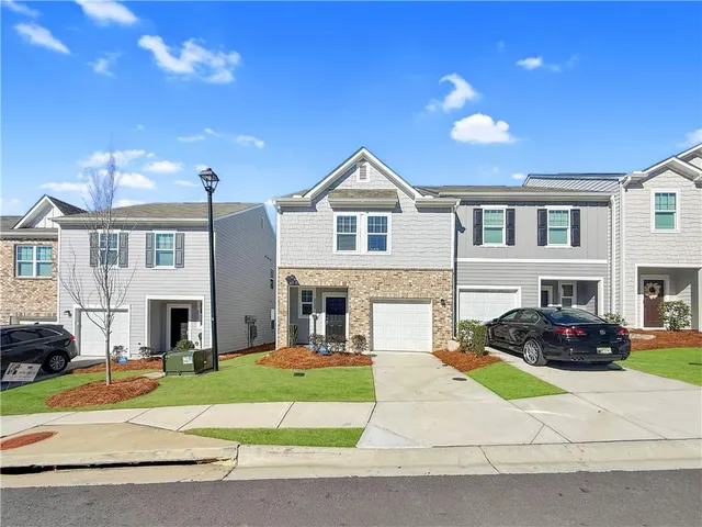 a front view of a house with a yard