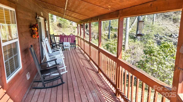 a view of balcony with furniture and wooden floor