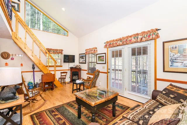 a living room with furniture and a floor to ceiling window