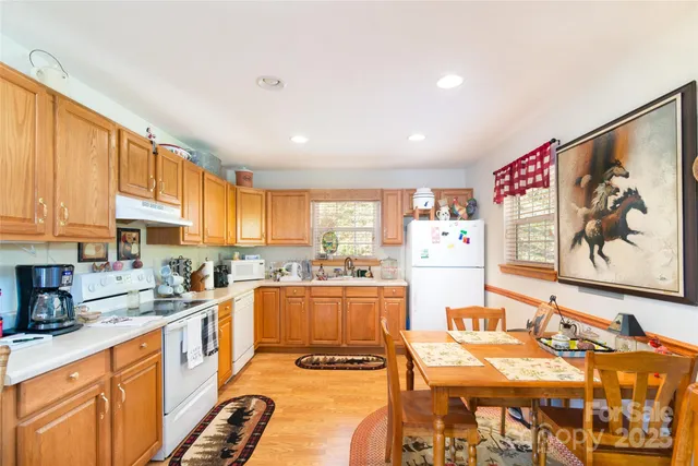 a large kitchen with a large window and stainless steel appliances