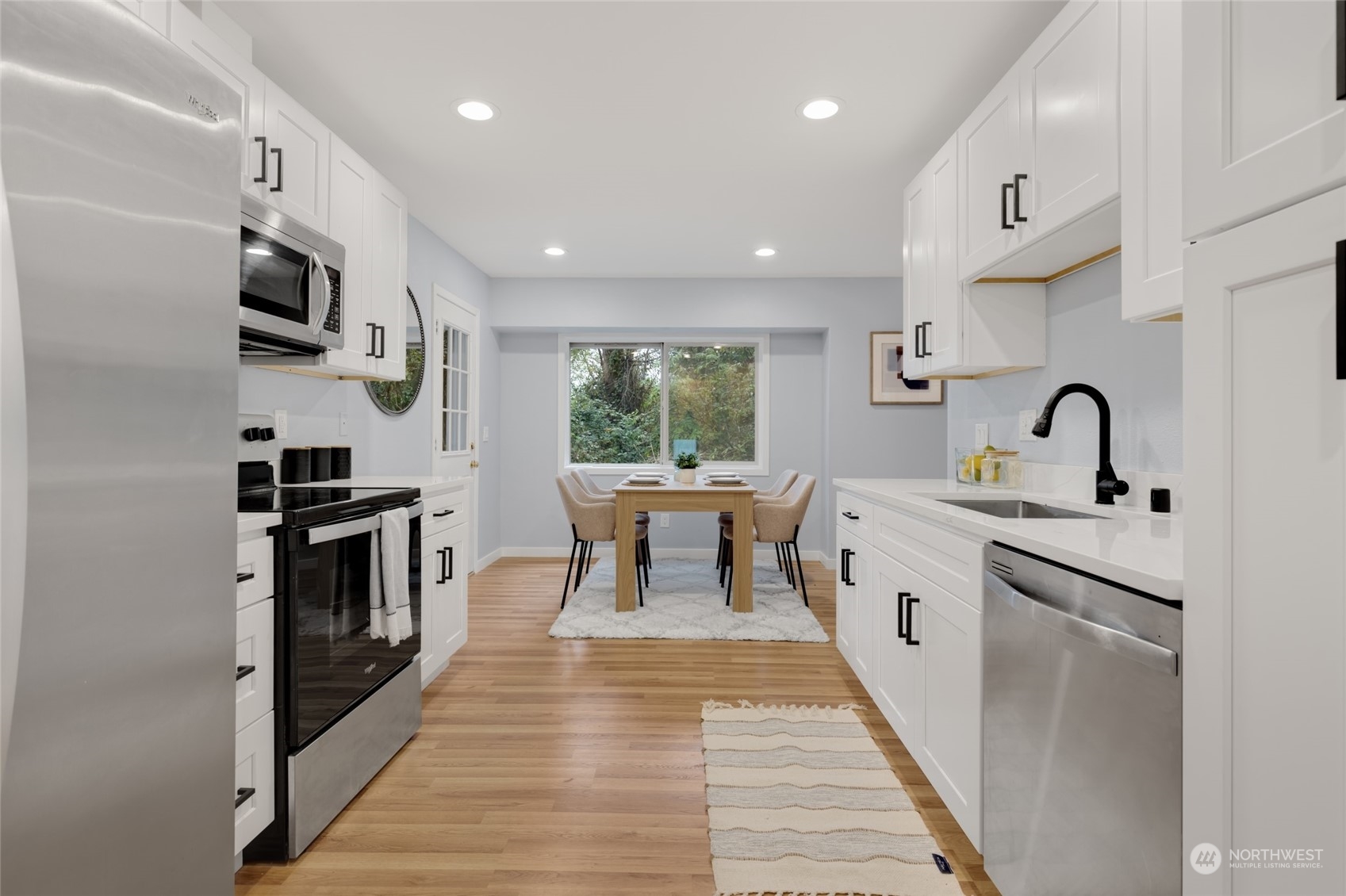 2409 180th Street Southeast Bothell, WA 98012 - Photo 13 of 40 a kitchen with stainless steel appliances granite countertop a stove a sink and a refrigerator