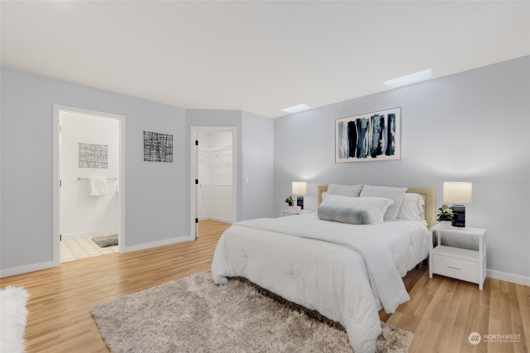 2409 180th Street Southeast Bothell, WA 98012 - Photo 18 of 40 a bedroom with a large bed and a chandelier