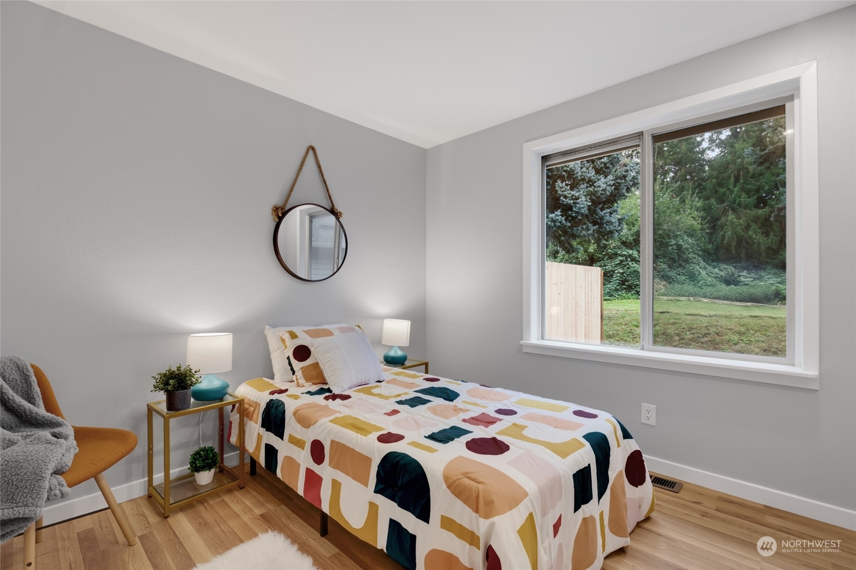 2409 180th Street Southeast Bothell, WA 98012 - Photo 25 of 40 a bedroom with a bed a table and windows
