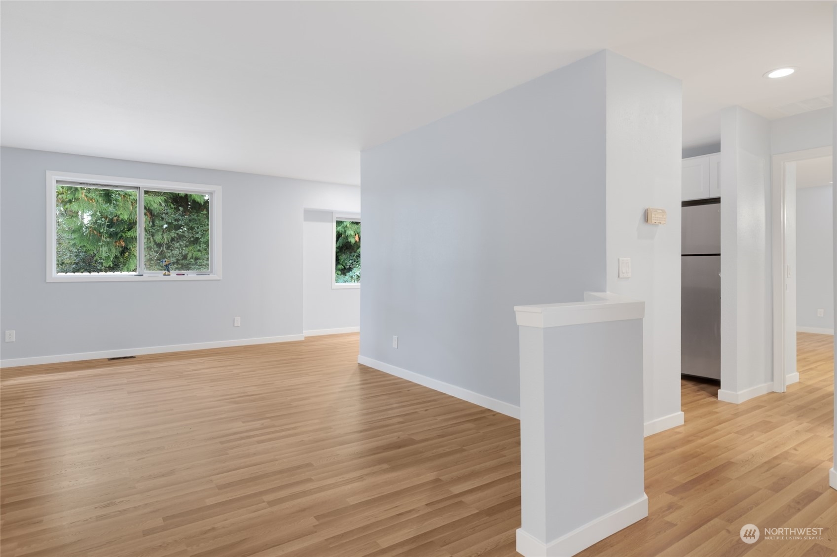 2409 180th Street Southeast Bothell, WA 98012 - Photo 32 of 40 a view of an empty room with wooden floor and a window