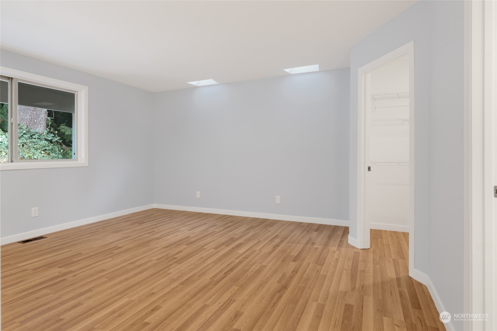 2409 180th Street Southeast Bothell, WA 98012 - Photo 34 of 40 a view of an empty room with wooden floor and a window