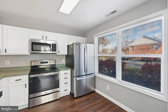 a kitchen with a stove a microwave and a refrigerator