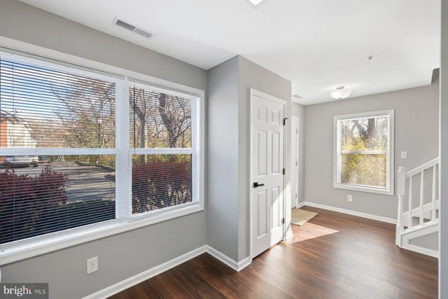 a view of a livingroom with wooden floor and a window