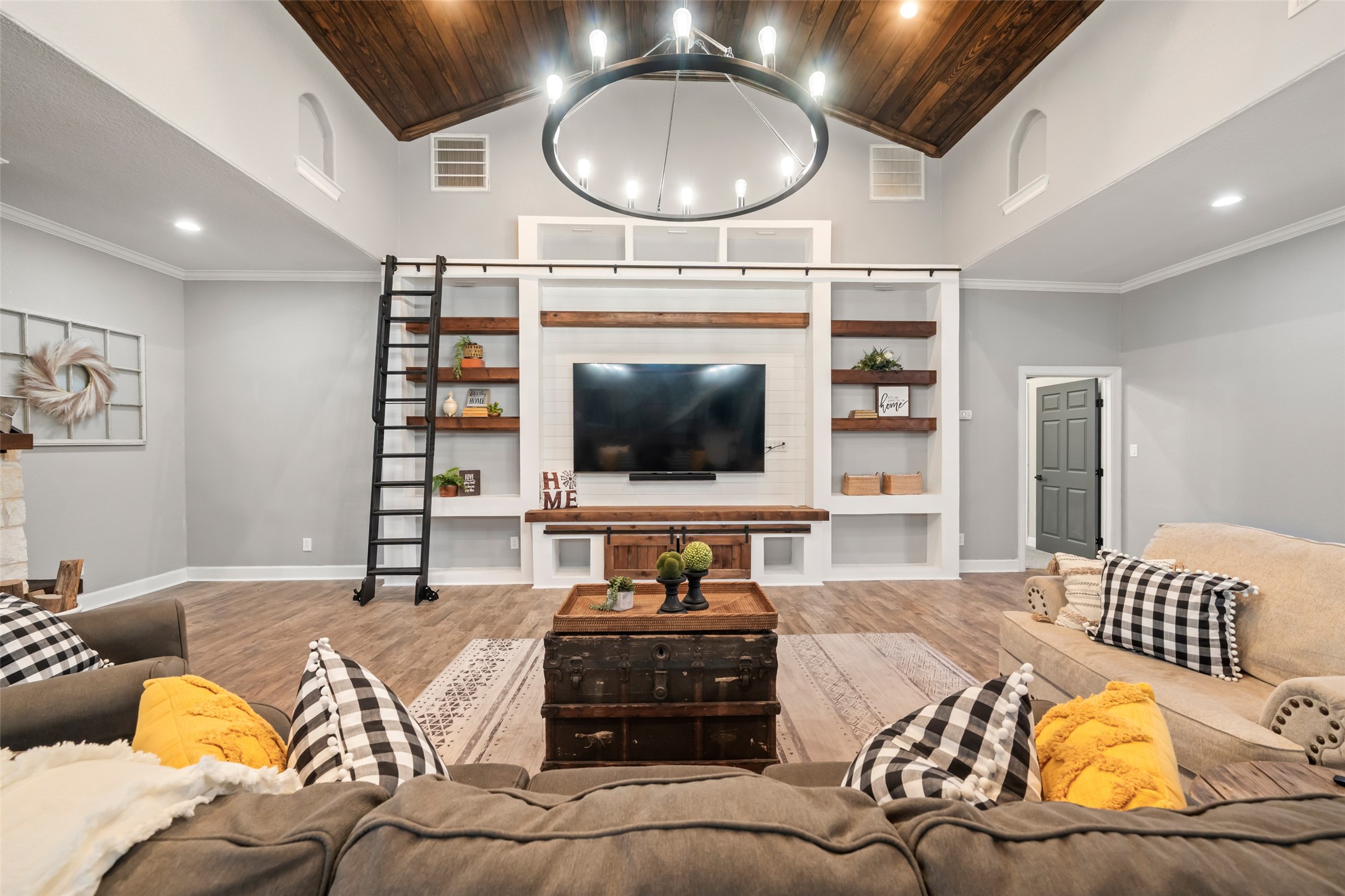 10630 Padon Road Needville, TX 77461 - Photo 13 of 50 Open-concept layout connects the living, dining, and kitchen areas under a continuous wood-paneled ceiling. The design supports both everyday living and entertaining.