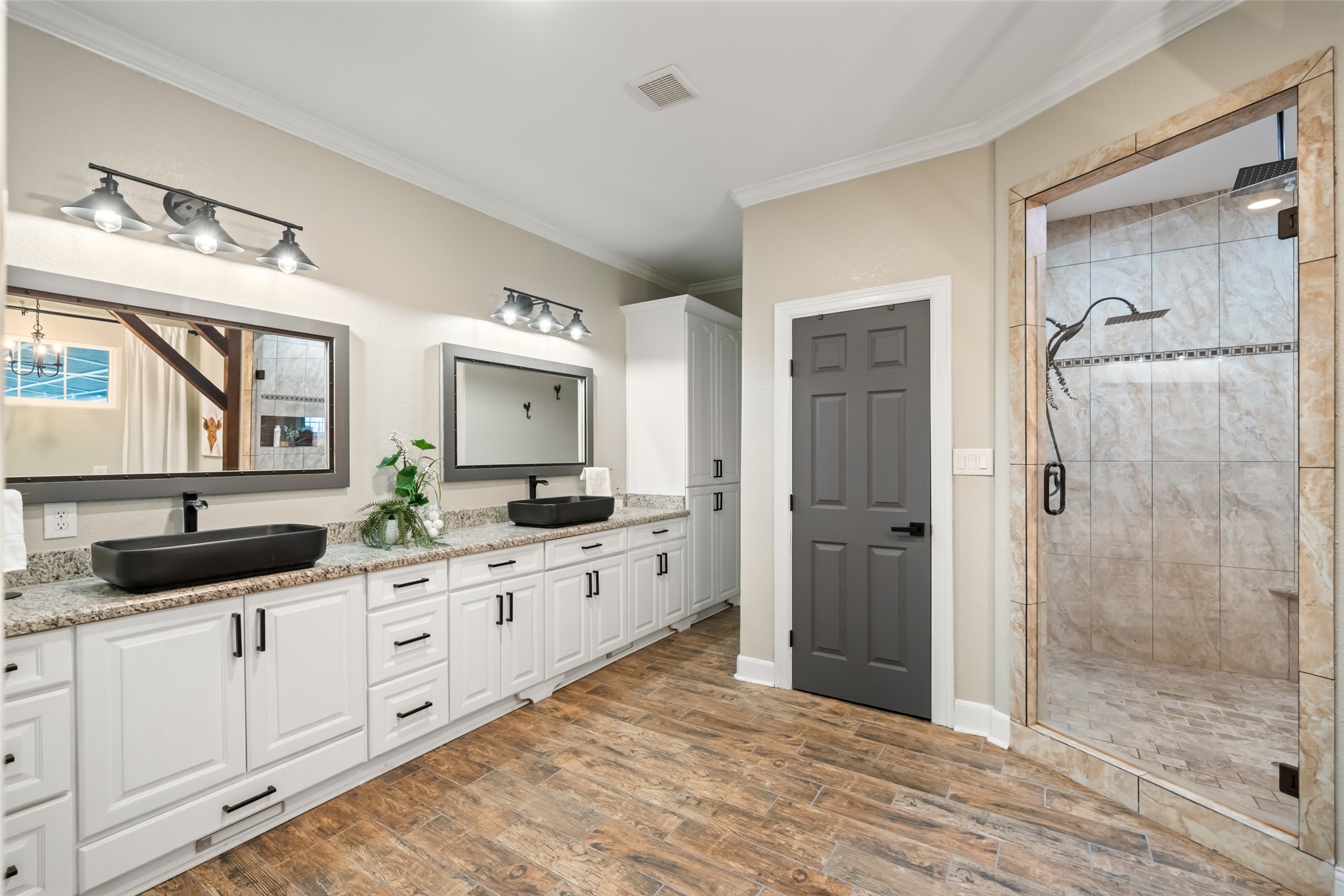 10630 Padon Road Needville, TX 77461 - Photo 24 of 50 Primary bathroom features a long double vanity with granite counters, vessel sinks, and updated lighting. Storage cabinetry supports everyday convenience.