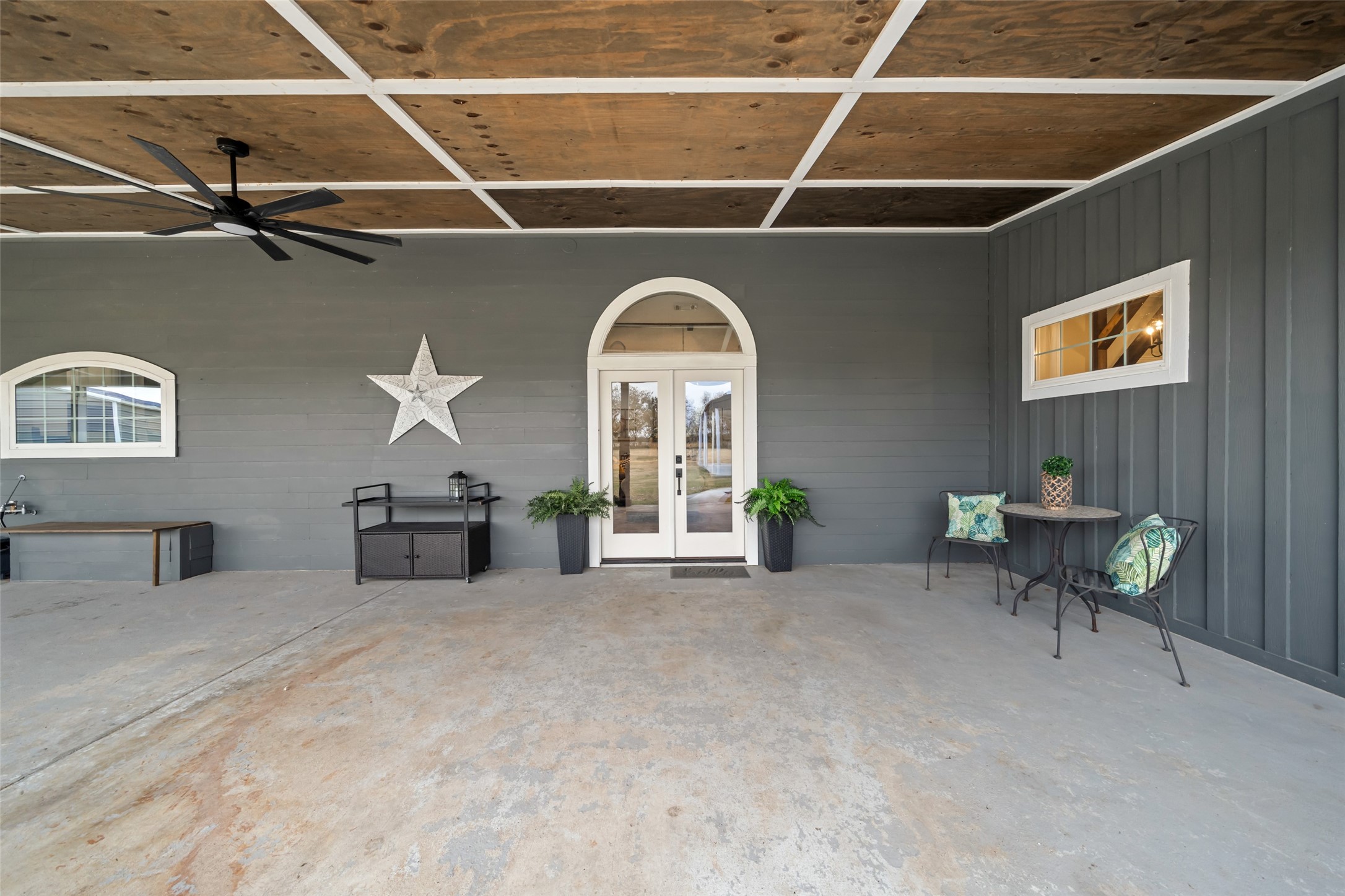 10630 Padon Road Needville, TX 77461 - Photo 3 of 50 Covered patio showcases finished ceiling panels, ceiling fan, and generous concrete space for seating or entertaining. Thoughtful finishes extend the living area outdoors.