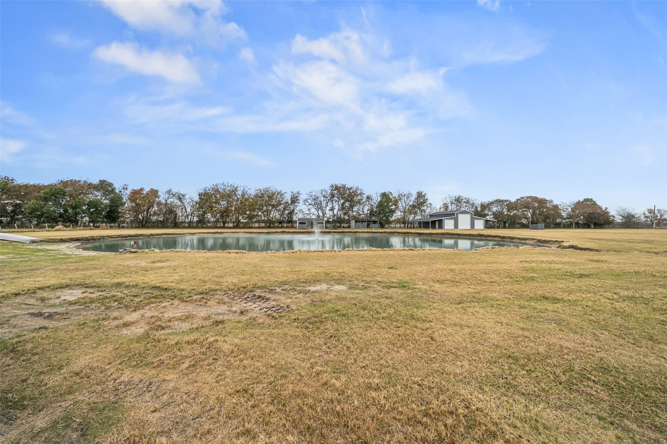 10630 Padon Road Needville, TX 77461 - Photo 35 of 50 Centrally located pond adds a scenic focal point and supports outdoor use of the acreage. Open surroundings allow for unobstructed views across the property.