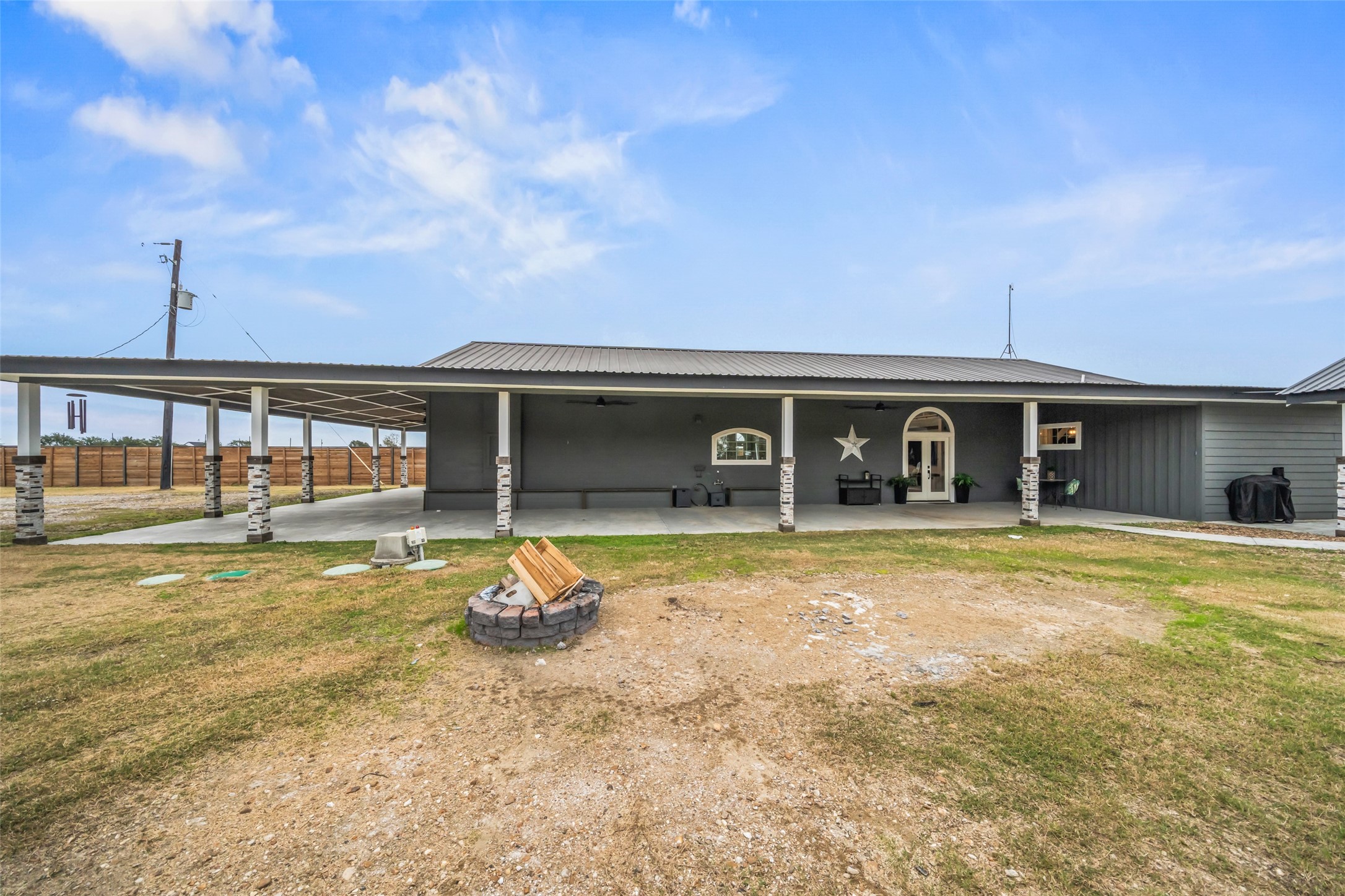 10630 Padon Road Needville, TX 77461 - Photo 8 of 50 Full-length covered porch showcases updated columns and thoughtful exterior finishes. Multiple entry points enhance indoor-outdoor flow.