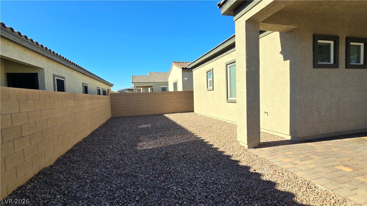 852 Weston Ridge Street Henderson, NV 89011 - Photo 28 of 28 A private backyard oasis awaits with a charming patio and low-maintenance xeriscape landscaping.