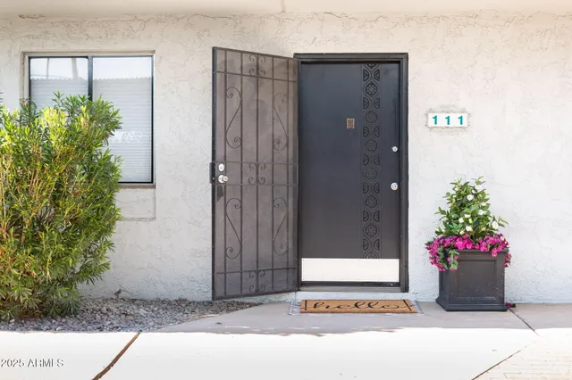a building with potted plants in front of door