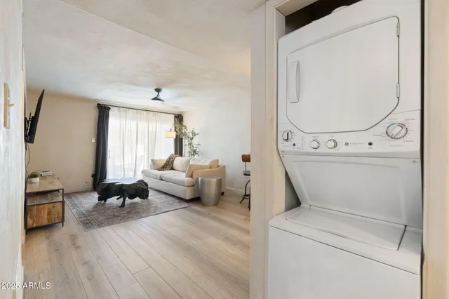 a living room with furniture and a large mirror