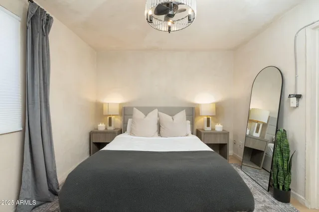 a bedroom with a bed and a mirror