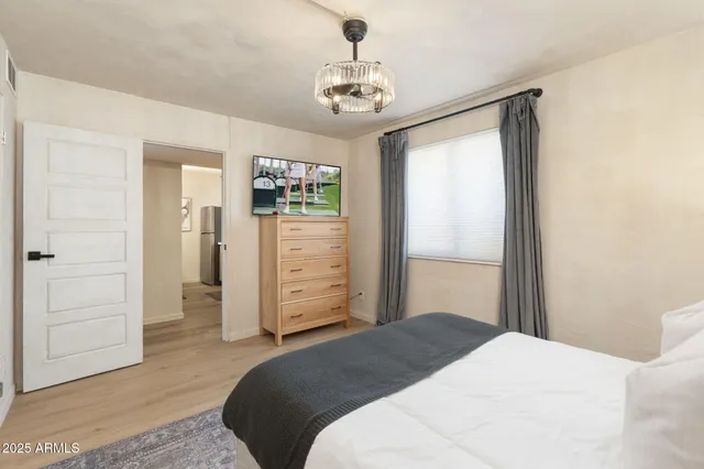 a bedroom with a bed and a window