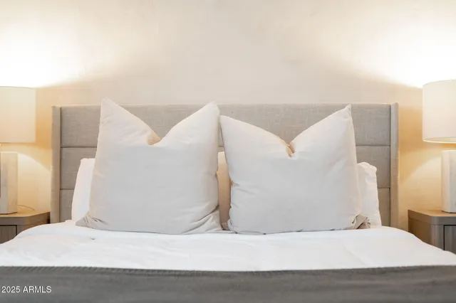 a bedroom with a bed and a night stand