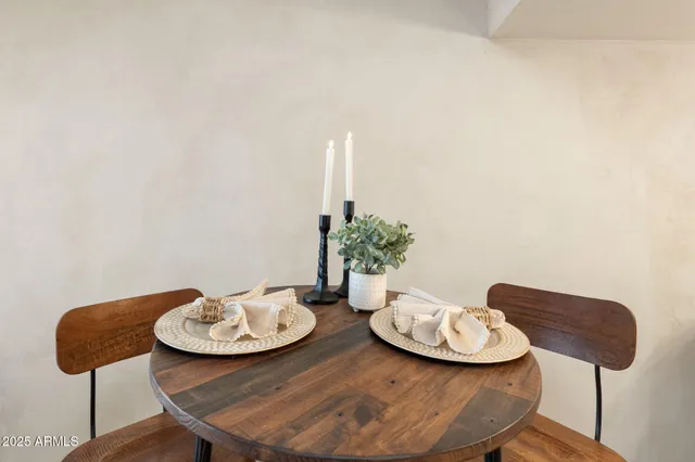 a table and chairs in a white room