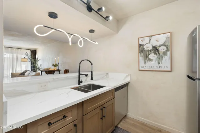 a kitchen with a sink and a mirror