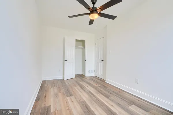 a view of a room with a ceiling fan