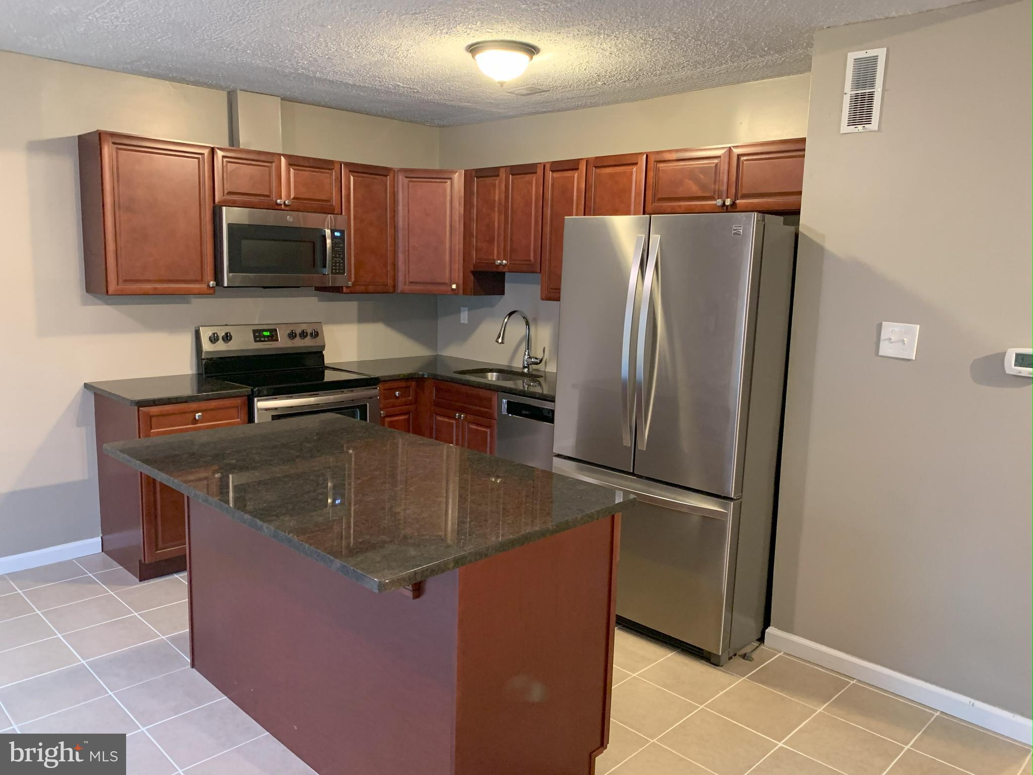 50 Georgetown Road Lindenwold, NJ 08021 - Photo 4 of 17 a kitchen with stainless steel appliances granite countertop a refrigerator a stove a sink and a microwave
