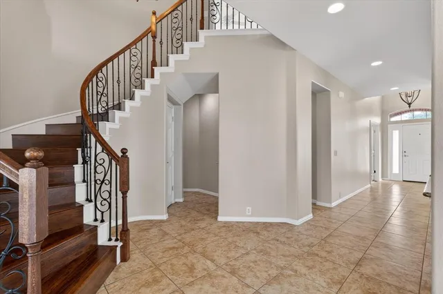 a view of entryway with wooden floor and stairs