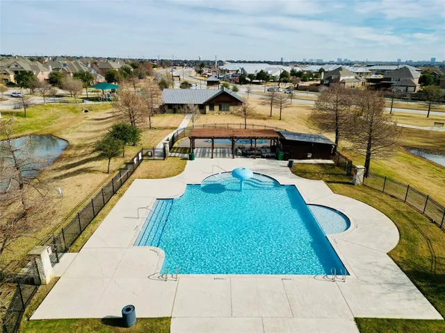 a view of a swimming pool with outdoor seating