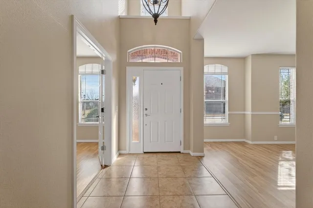 a view of a hallway with wooden floor and a living room