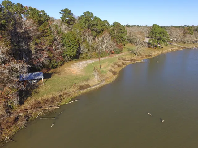 a patio with wooden floor table and chairs