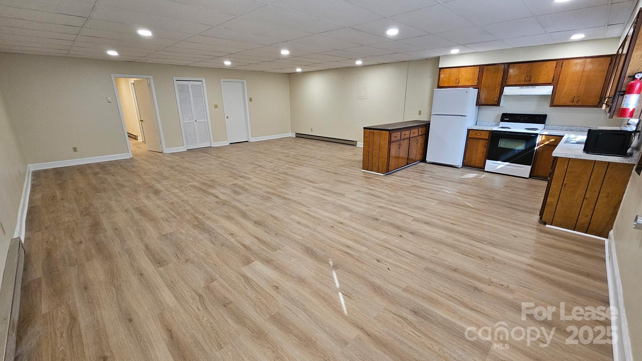 321 Connelly Springs Road, Unit A Lenoir, NC 28645 - Photo 2 of 12 a view of kitchen with stainless steel appliances wooden floor and large window