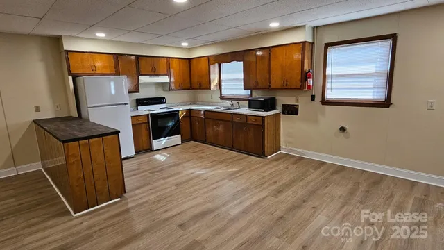 a kitchen with stainless steel appliances granite countertop refrigerator sink and cabinets