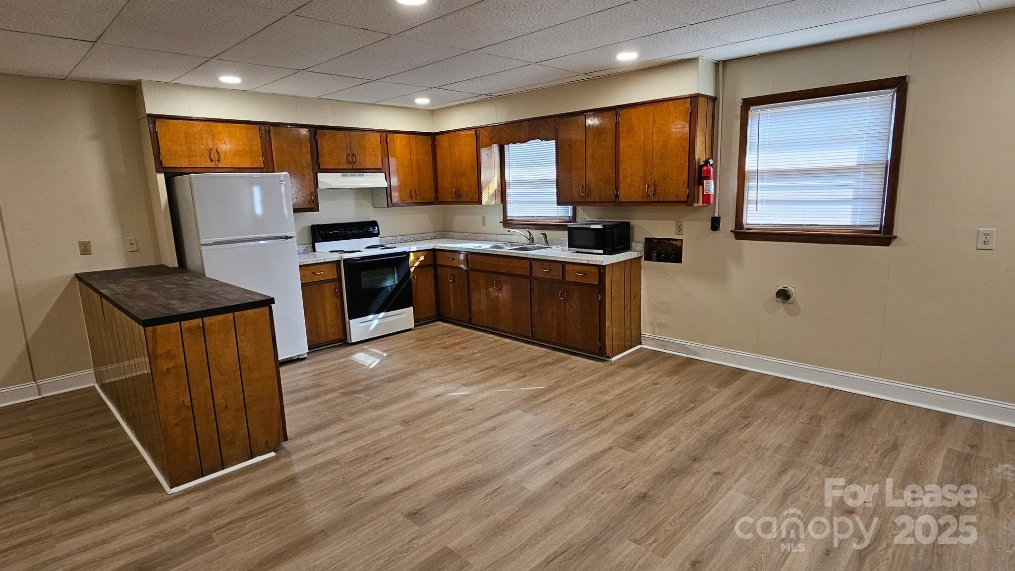 321 Connelly Springs Road, Unit A Lenoir, NC 28645 - Photo 3 of 12 a kitchen with stainless steel appliances granite countertop refrigerator sink and cabinets