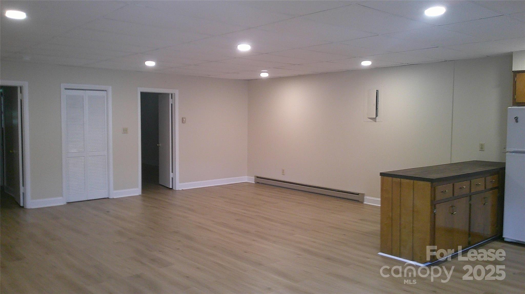321 Connelly Springs Road, Unit A Lenoir, NC 28645 - Photo 6 of 12 a view of an empty room with wooden floor